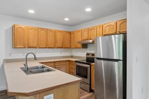 Kitchen with oak cabinets, a sink peninsula, and stainless steel appliances at Roberts Court Townhomes in Gresham, Oregon