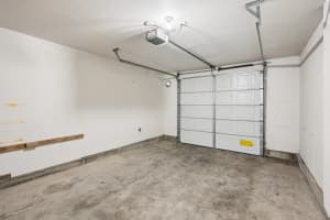 Empty garage with concrete flooring and a ceiling-mounted door opener at Roberts Court Townhomes in Gresham, Oregon