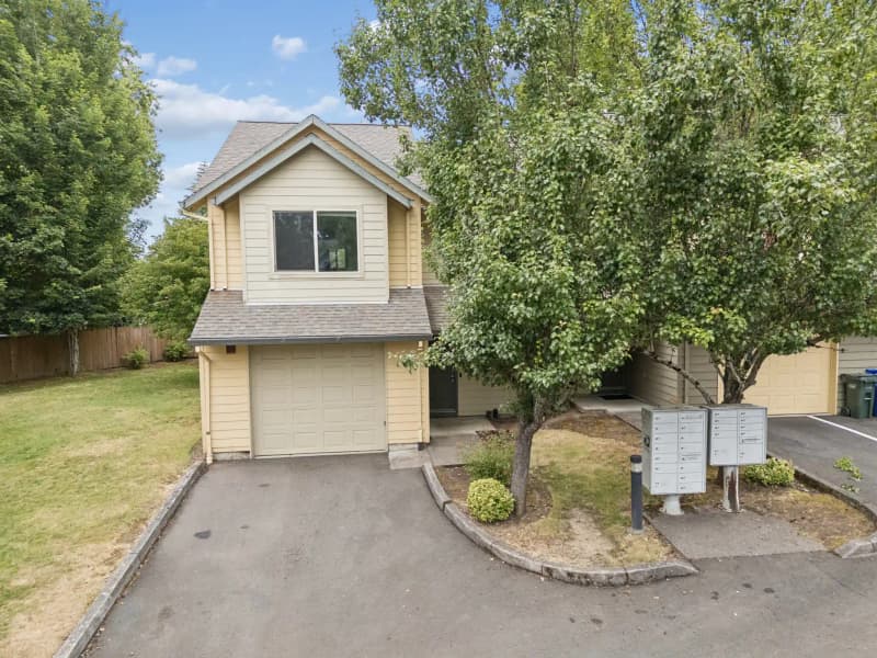 Roberts Court townhome with attached garage and mature trees