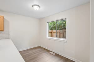 Dining nook with wood-look flooring and a window overlooking greenery at Roberts Court Townhomes in Gresham, Oregon