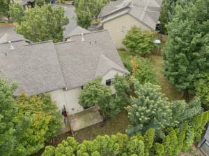 Aerial view of townhomes with concrete patios surrounded by mature trees at Roberts Court Townhomes in Gresham, Oregon