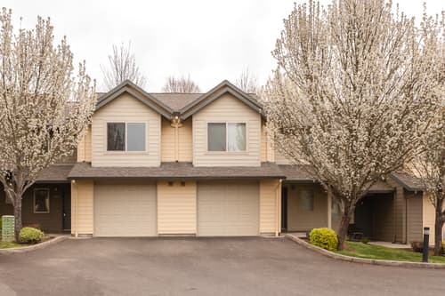 Roberts Court Townhomes exterior with blooming trees