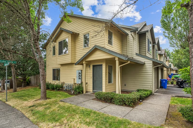 Roberts Court Townhomes two-story townhome with covered front entry, lawn, and mature trees in Gresham, Oregon