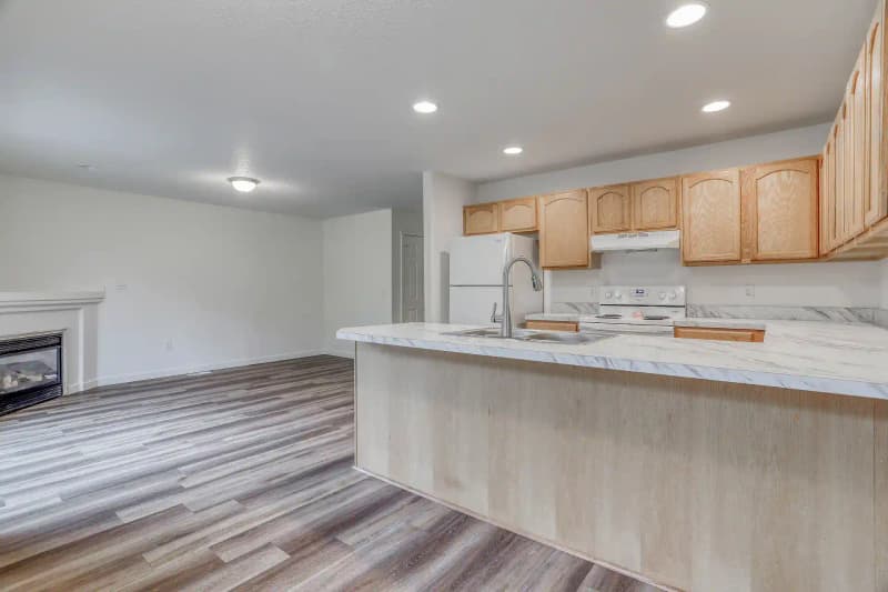 Roberts Court Townhomes kitchen with stainless steel appliances, quartz countertops, and custom cabinetry